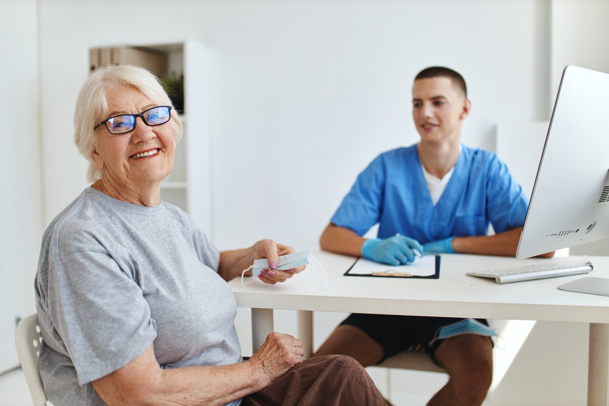 elderly woman patient sitting in the doctor s office health care